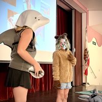 Students learn about the physical characteristics of marine mammals by dressing up as a dolphin and otter in the Dolphin Doctor Workshop